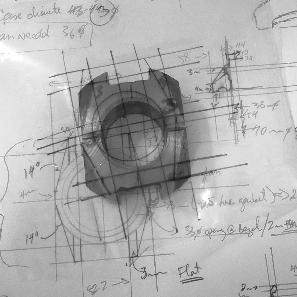 Placing the case against a quadrant drawing and a stencil to mark out the general lines to be milled away.