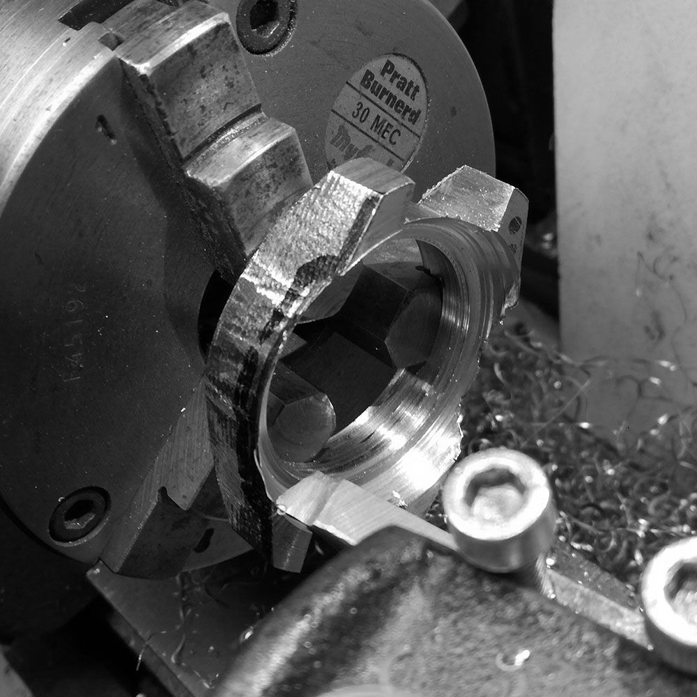 The depth of the lugs will have to be reduced, and then diameter reduced.